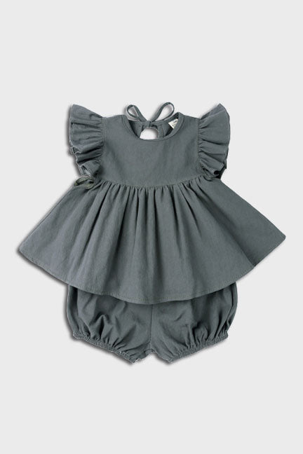 A stylish 2 pc set in vintage green featuring a flowing dress-like top with flutter sleeves and matching bloomer bottoms.