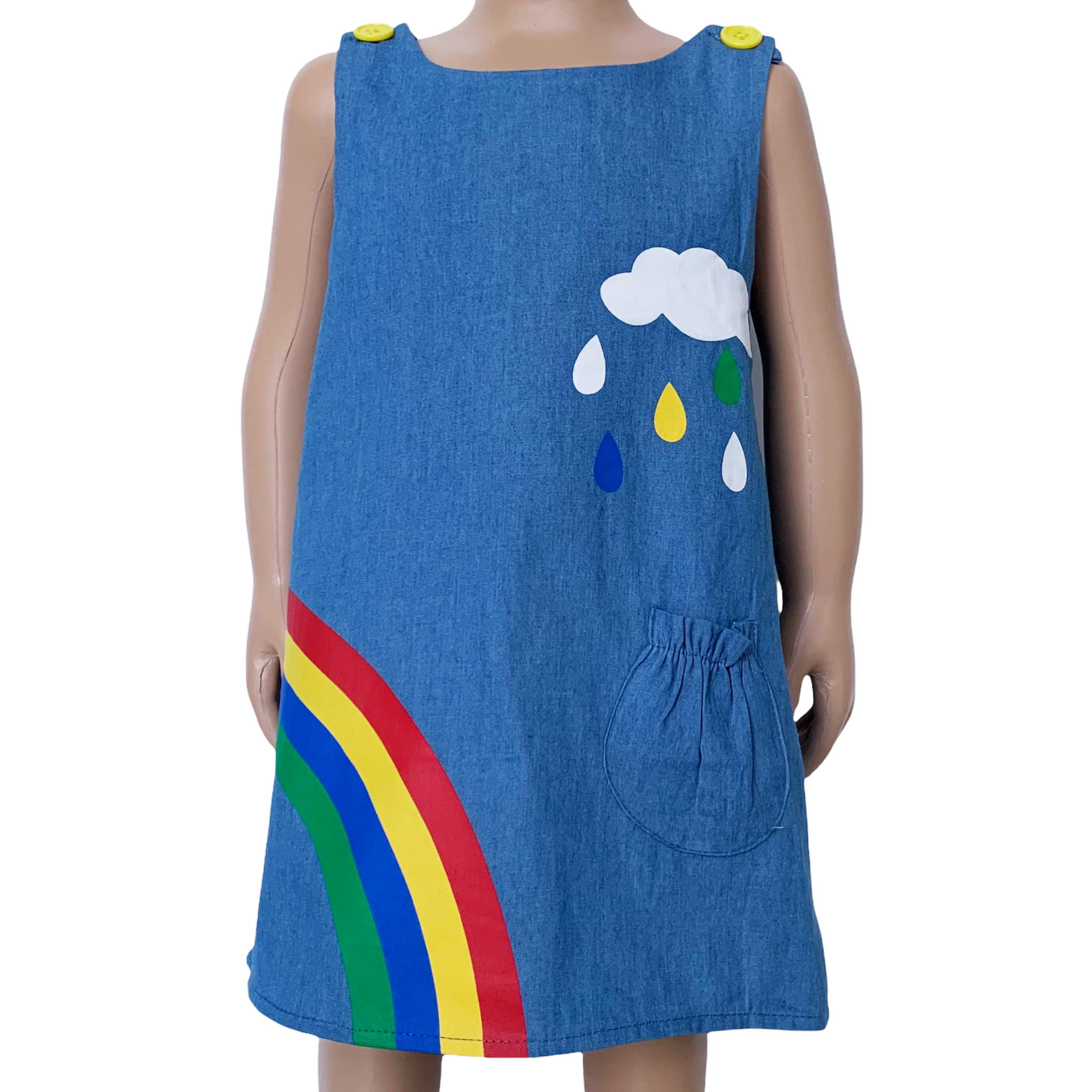 AL Limited Girls Blue Chambray Rainbow Overall Dress featuring a rainbow and cloud applique with yellow buttons on the shoulders.