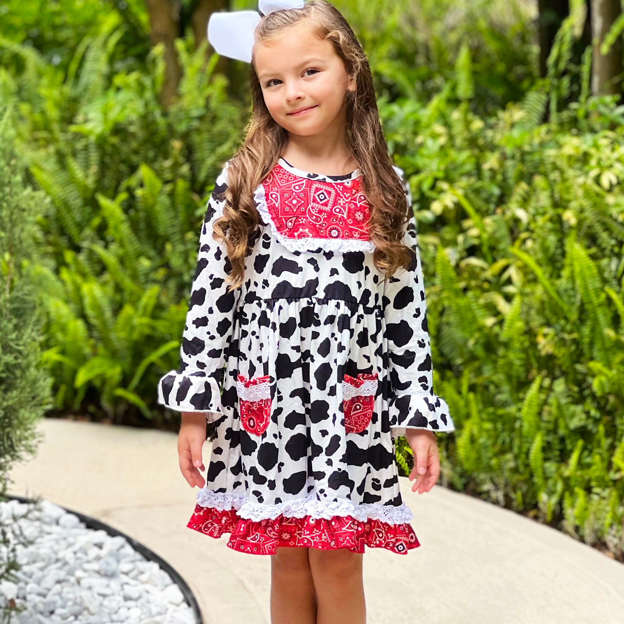 AL Limited Girls Boutique Cowgirl Dress featuring playful cow print and red bandana trimming with white eyelet ruffle accents.