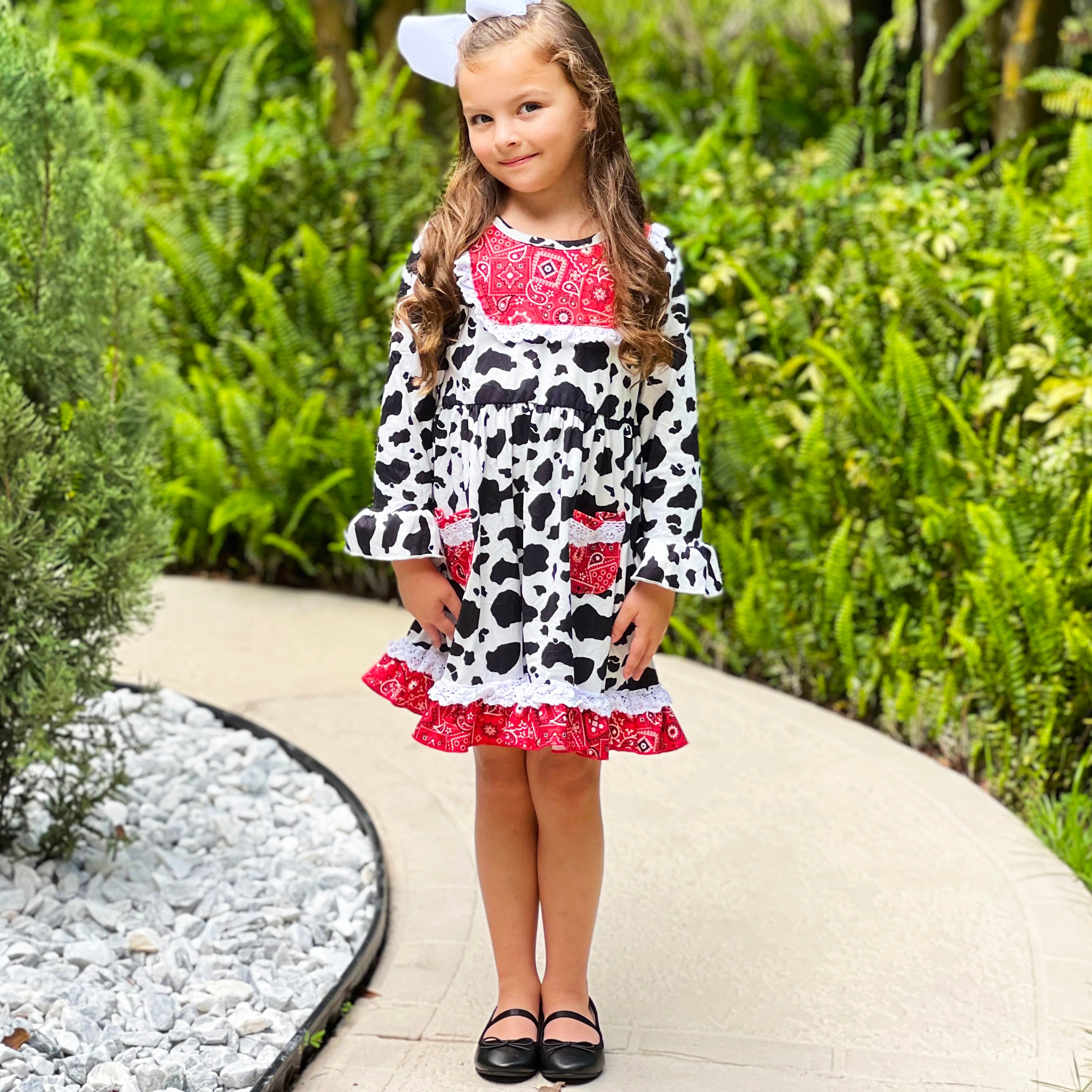 AL Limited Girls Boutique Cowgirl Dress featuring playful cow print and red bandana trimming with white eyelet ruffle accents.