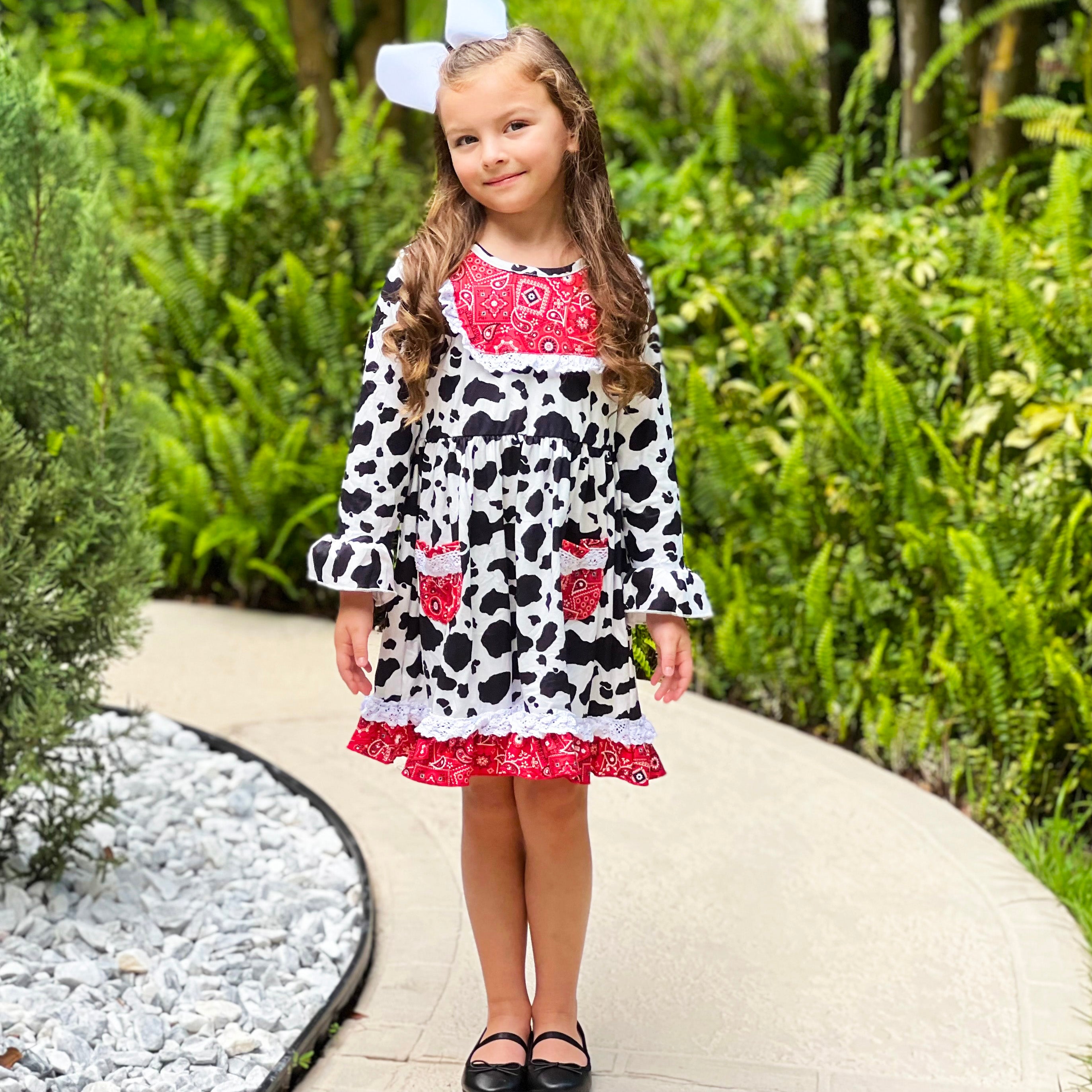 AL Limited Girls Boutique Cowgirl Dress featuring playful cow print and red bandana trimming with white eyelet ruffle accents.