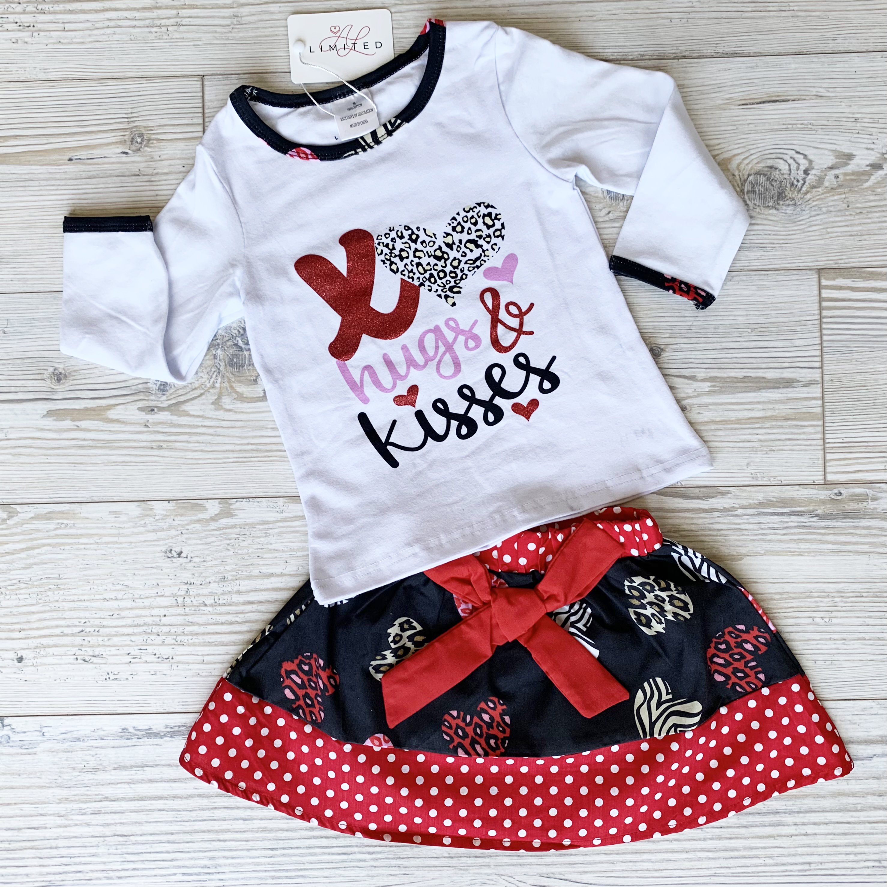 AL Limited Girls Valentine's Day Long Sleeve Shirt with Hearts Skirt Set featuring XO Hugs & Kisses design and a big red bow.