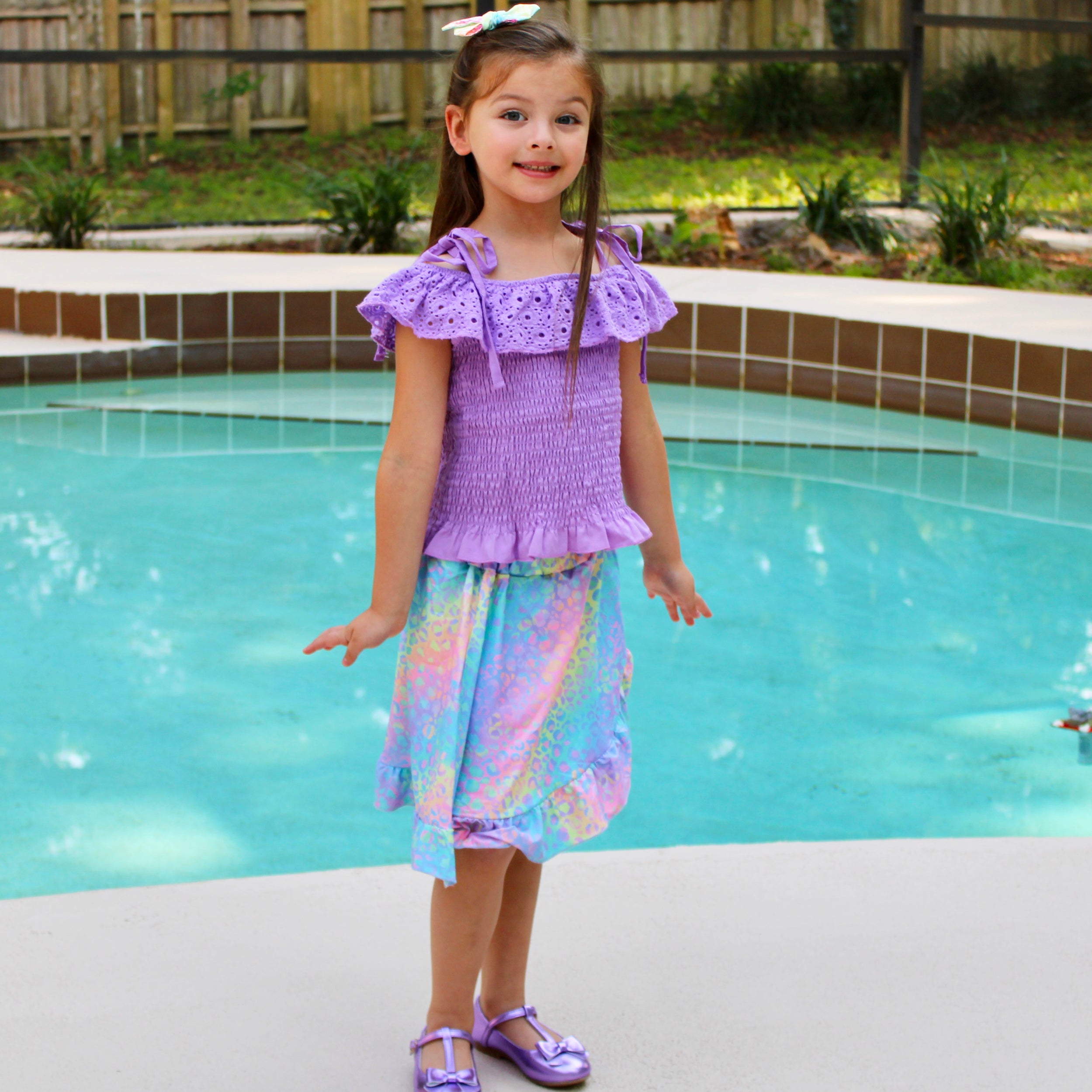 AL Limited Little & Big Girls Purple Eyelet Smocked Top with Tie Dye Skirt, showcasing vibrant colors and stylish design.