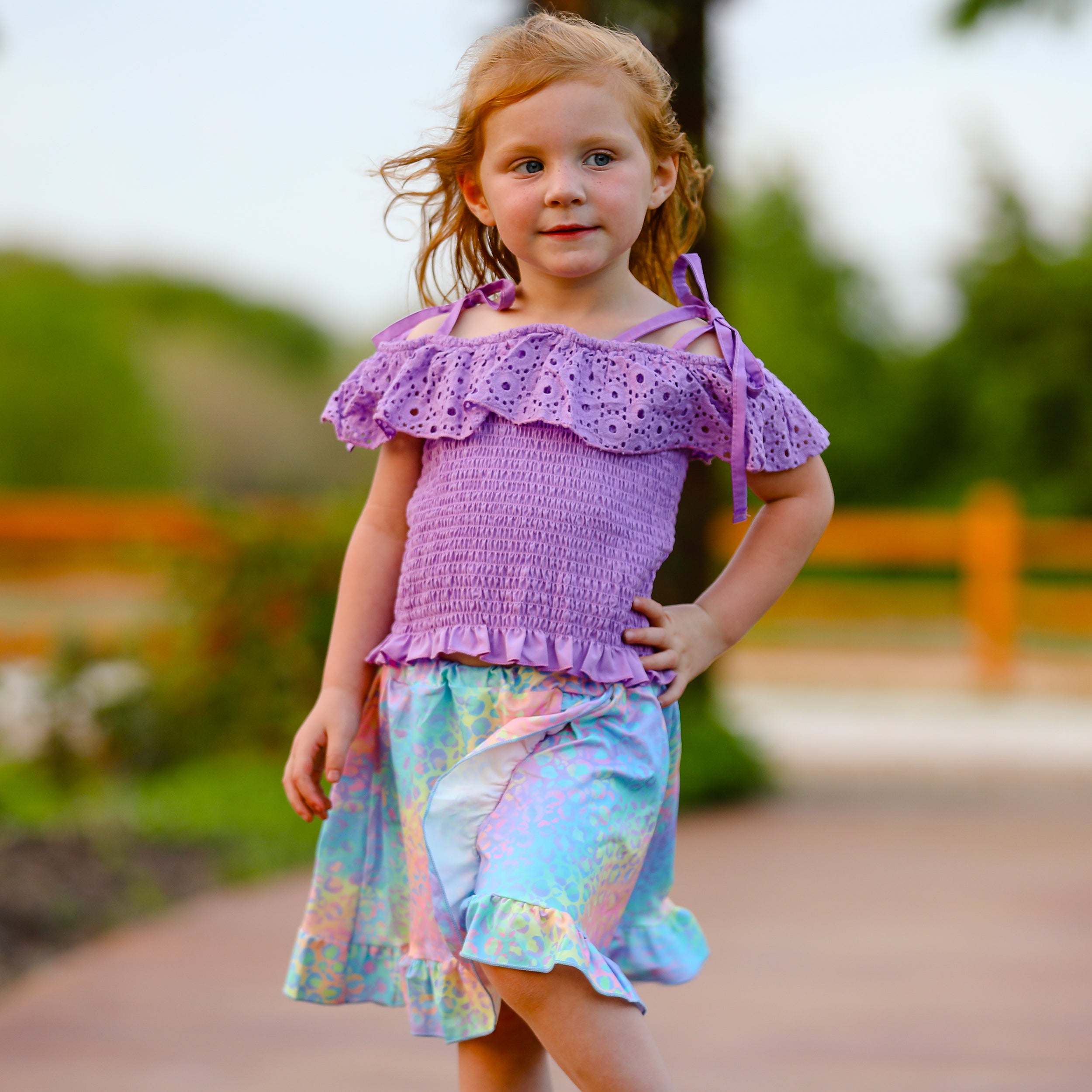 AL Limited Little & Big Girls Purple Eyelet Smocked Top with Tie Dye Skirt, showcasing vibrant colors and stylish design.