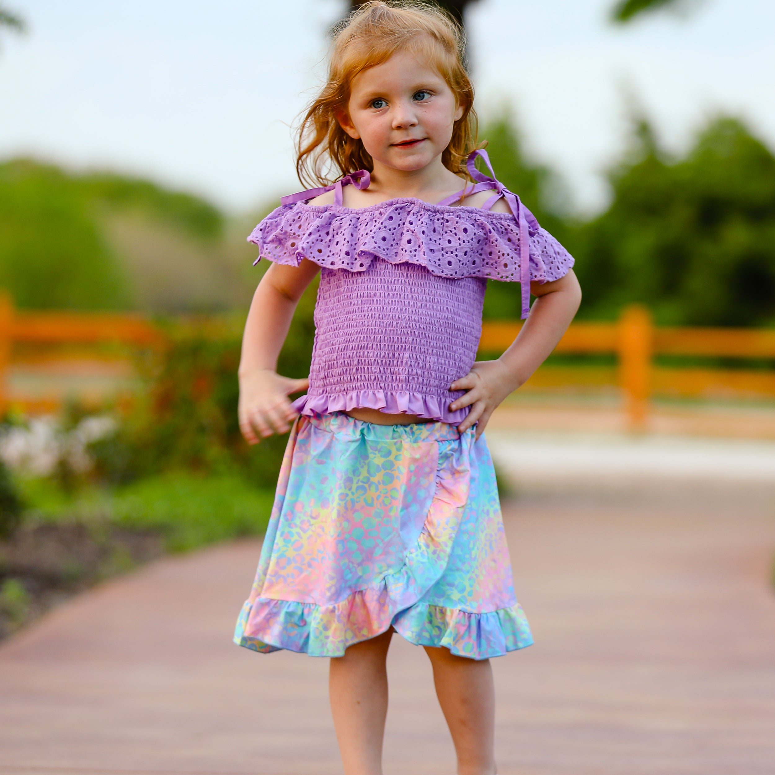 AL Limited Little & Big Girls Purple Eyelet Smocked Top with Tie Dye Skirt, showcasing vibrant colors and stylish design.