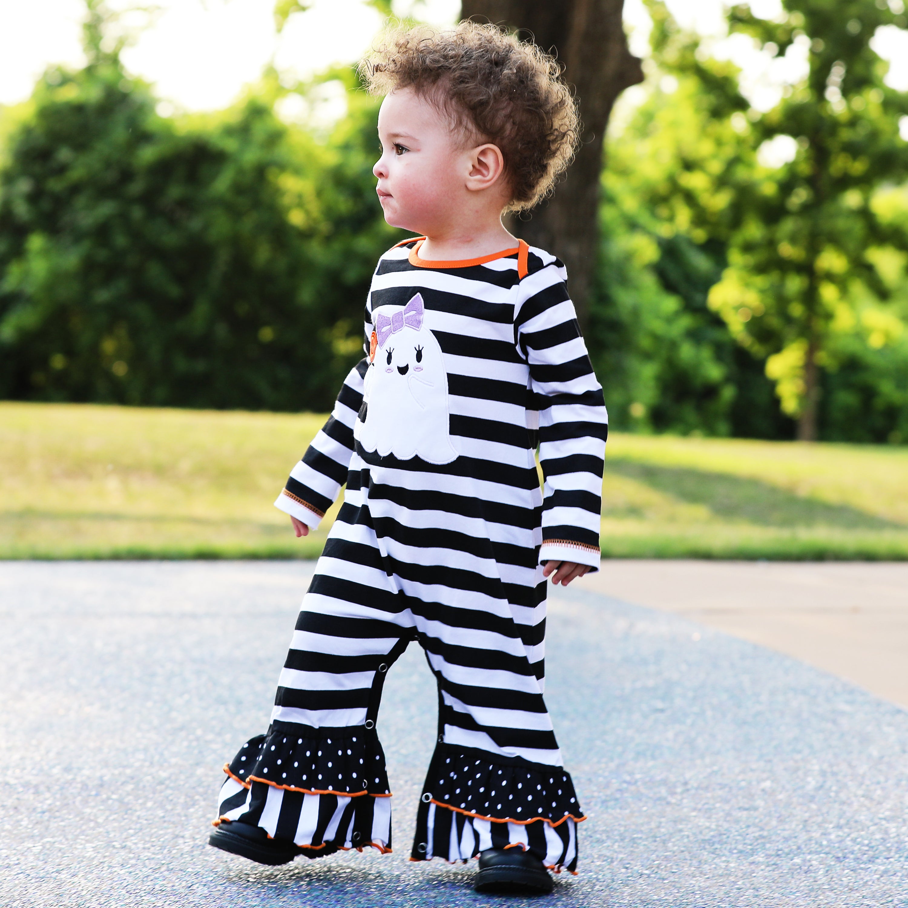 AnnLoren Baby Girls Halloween romper featuring friendly ghost applique and black and white stripes with polka dot ruffles.