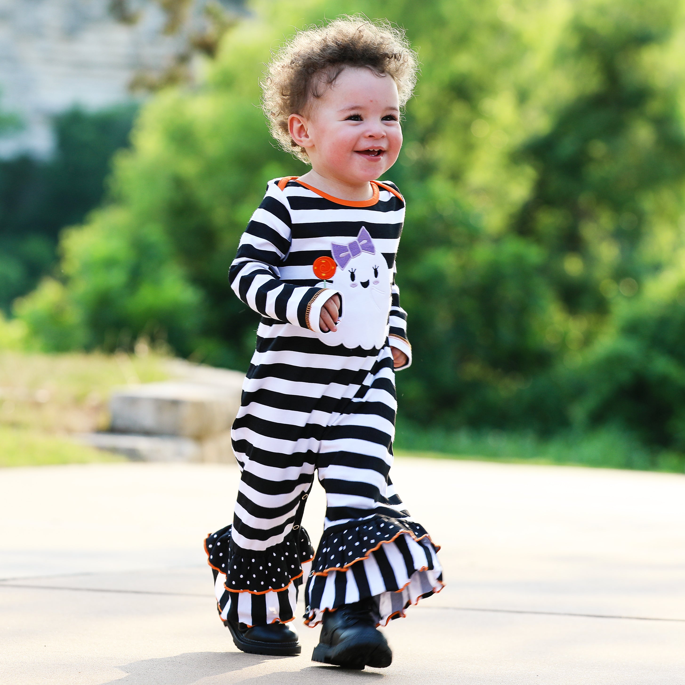 AnnLoren Baby Girls Halloween romper featuring friendly ghost applique and black and white stripes with polka dot ruffles.