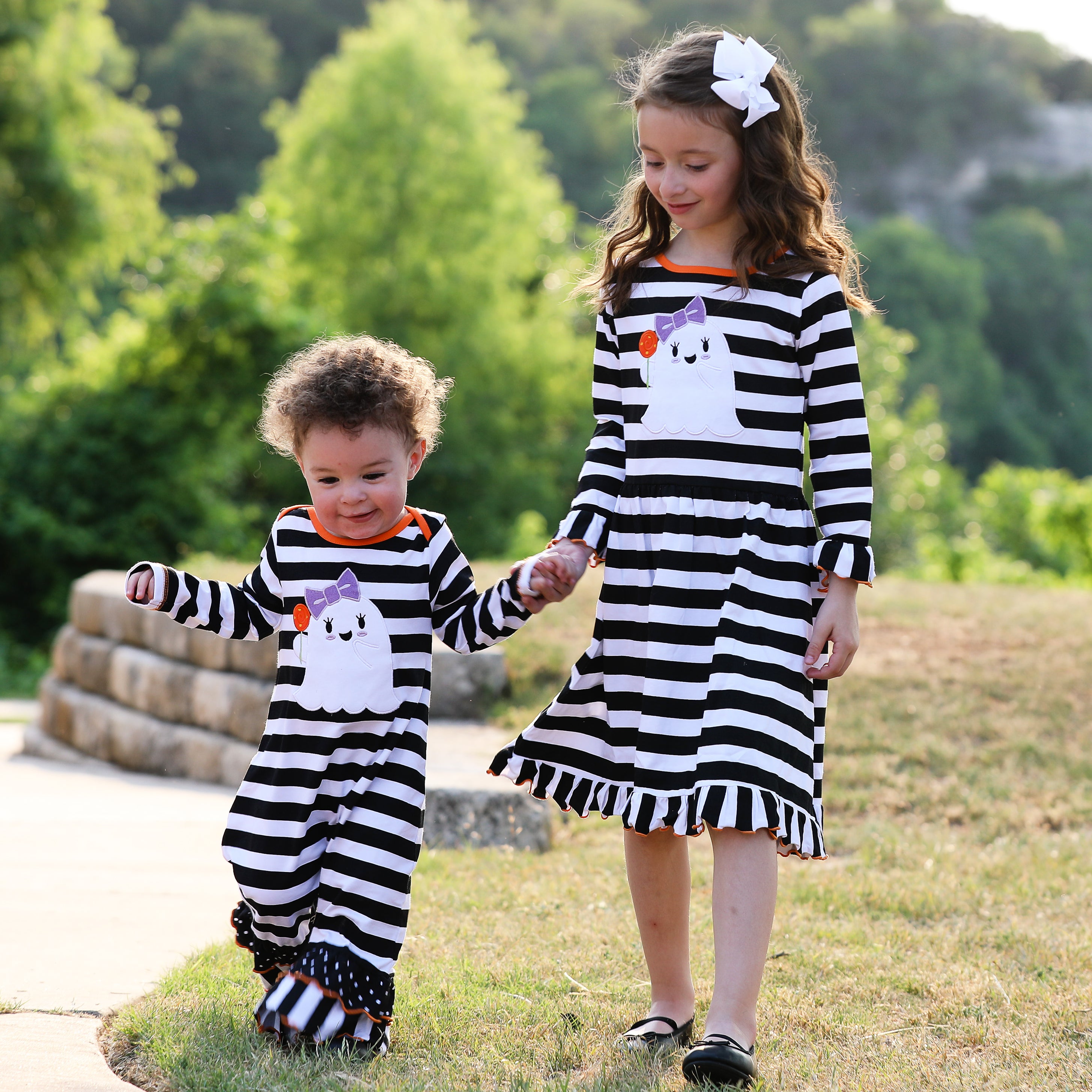 AnnLoren Baby Girls Halloween romper featuring friendly ghost applique and black and white stripes with polka dot ruffles.