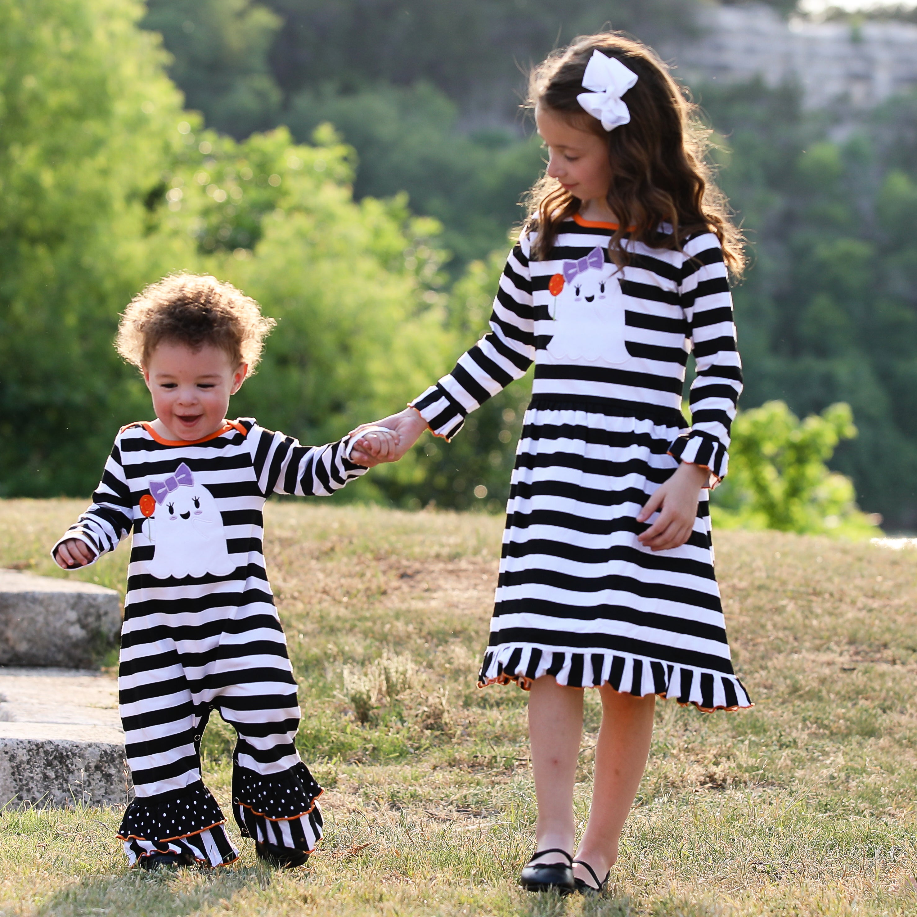 AnnLoren Baby Girls Halloween romper featuring friendly ghost applique and black and white stripes with polka dot ruffles.