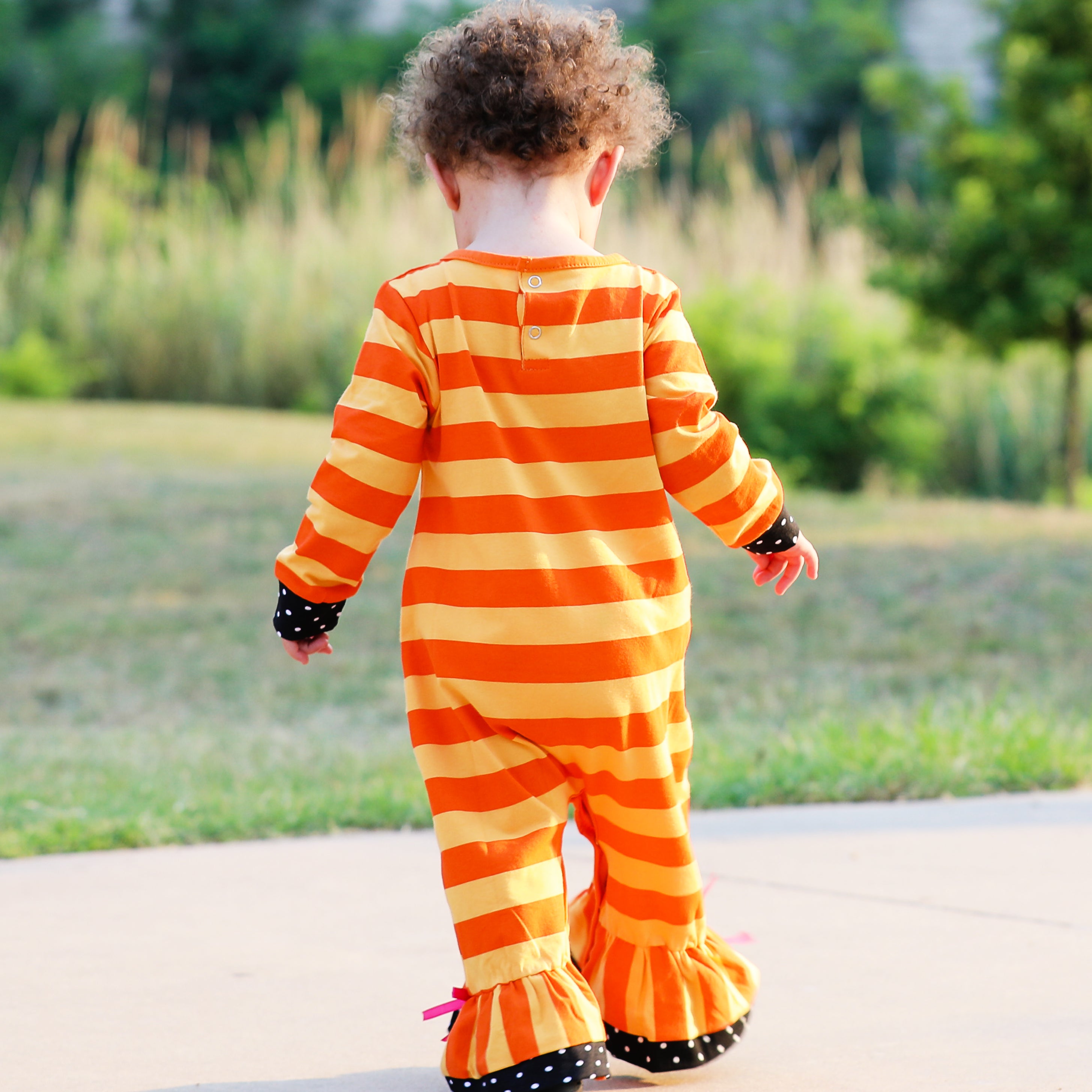 AnnLoren Baby Girls Halloween romper featuring a friendly black cat applique and orange striped design with polka dot trim.