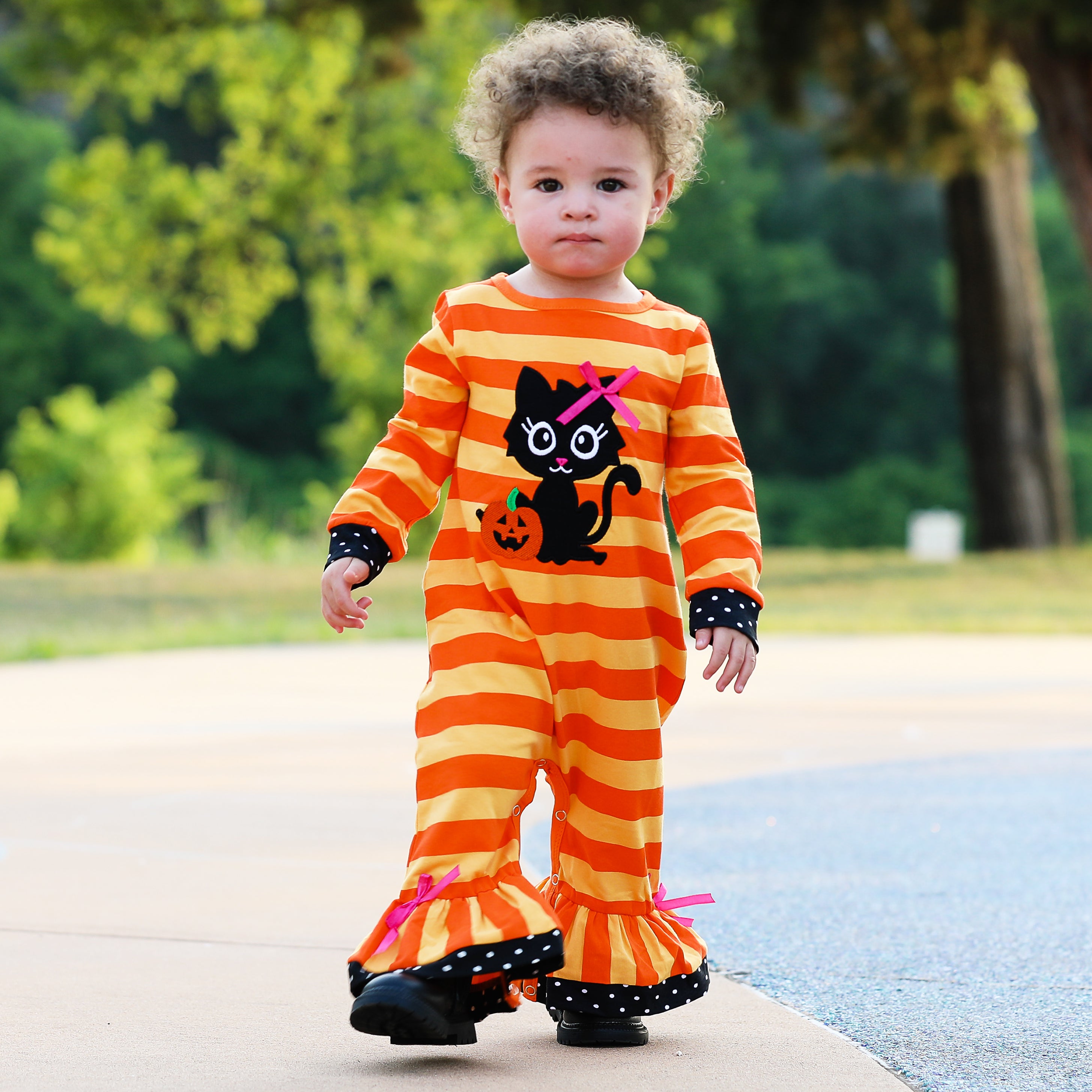 AnnLoren Baby Girls Halloween romper featuring a friendly black cat applique and orange striped design with polka dot trim.