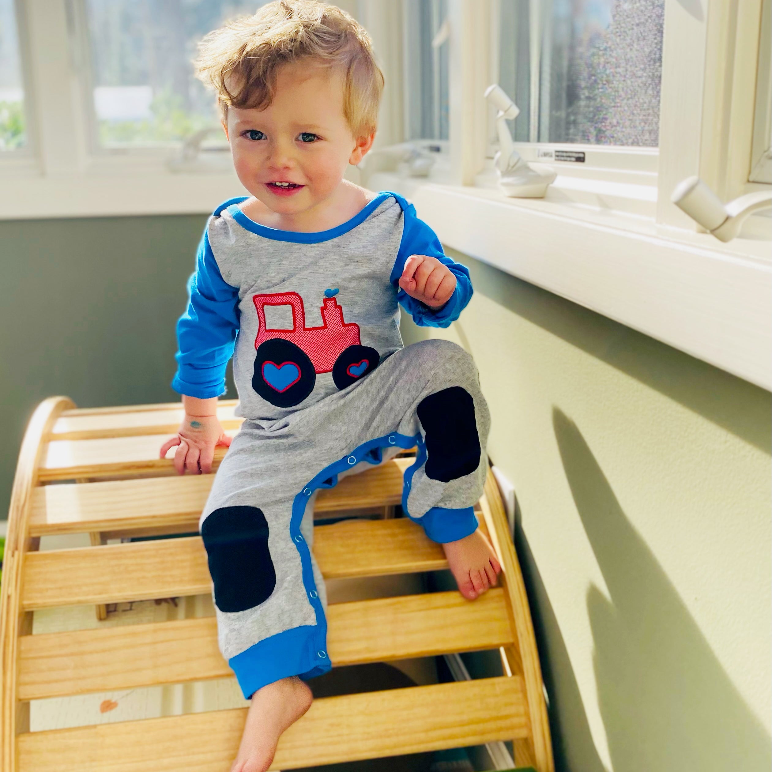 AnnLoren Baby Toddler Boys Long Sleeve Truck Romper in blue and grey with red truck appliqué and knee patches.