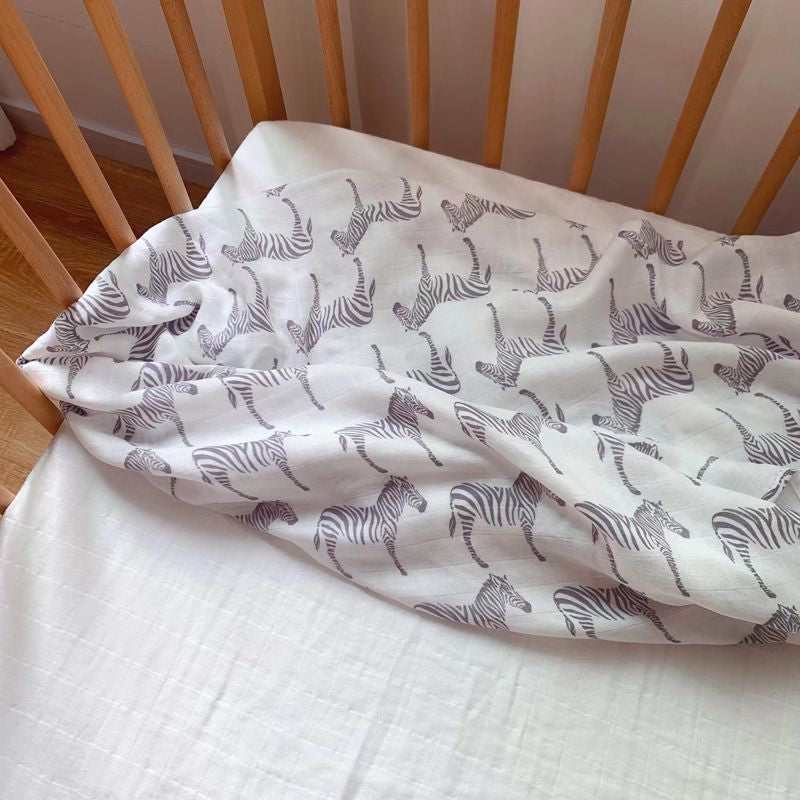 A soft and breathable Bamboo Swaddle made from 70% bamboo and 30% cotton, measuring 47" x 47", perfect for wrapping babies.