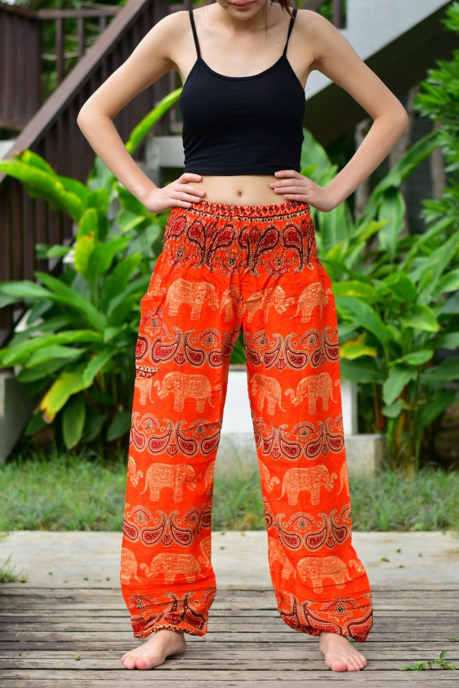 Bohotusk Kids Orange Elephant Harem Trousers with elasticated waist and ankles, featuring a vibrant elephant design.