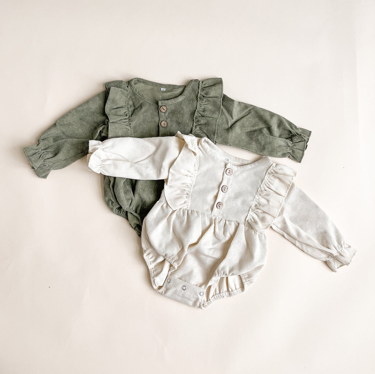 A stylish corduroy romper made from soft cotton, showcasing its unique texture and design.