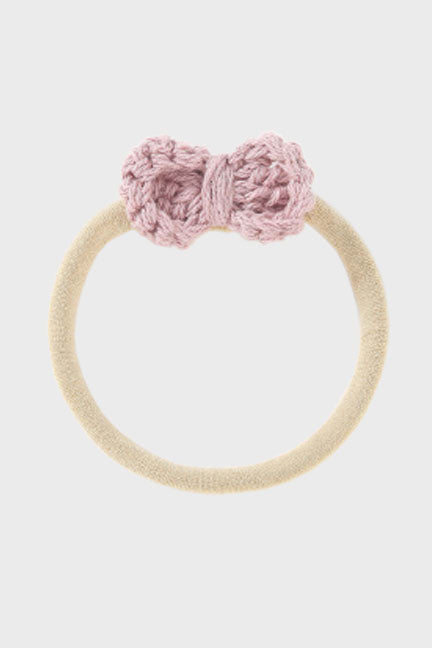 A soft crochet bow headband for babies, featuring a delicate bow design on a stretchy nylon band, perfect for ages newborn to 3 years.