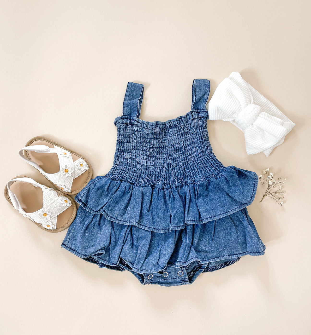 A stylish denim romper made from soft cotton, featuring a comfortable fit and casual design, perfect for various occasions.