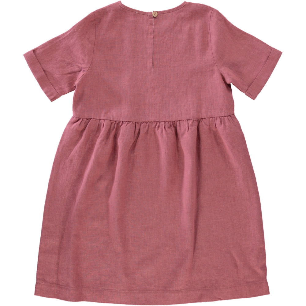 A soft linen dress in rose and blue celeste colors, featuring a loose fit and an olive wood button closure on the back.