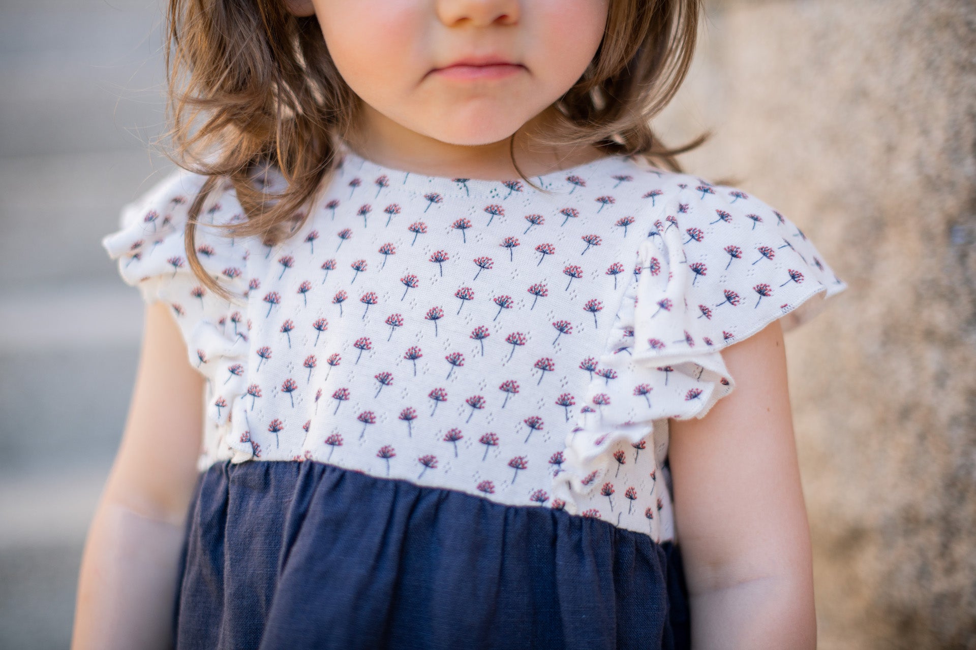 Dress Daisy Flower Blue featuring organic cotton top with floral print and blue linen bottom, adorned with butterfly frills.