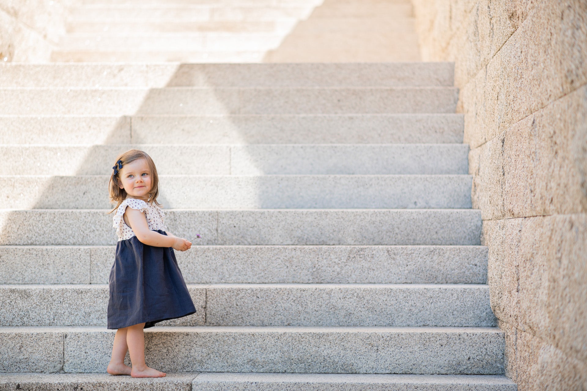 Dress Daisy Flower Blue featuring organic cotton top with floral print and blue linen bottom, adorned with butterfly frills.