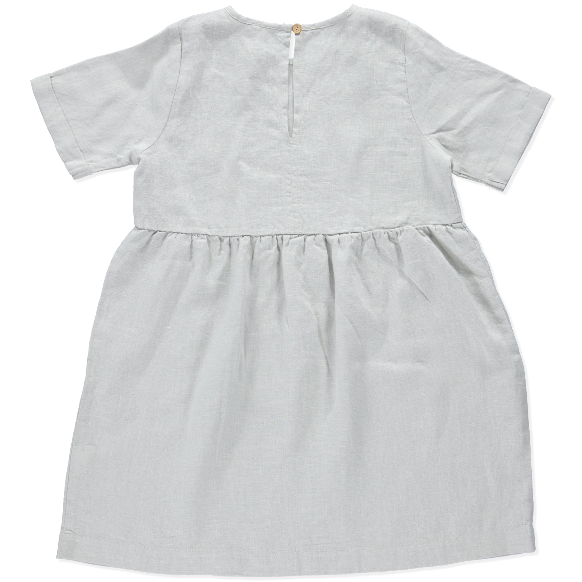 A modern casual dress in cream color made of soft linen, featuring rolled cuff sleeves and an olive wood button closure at the back.