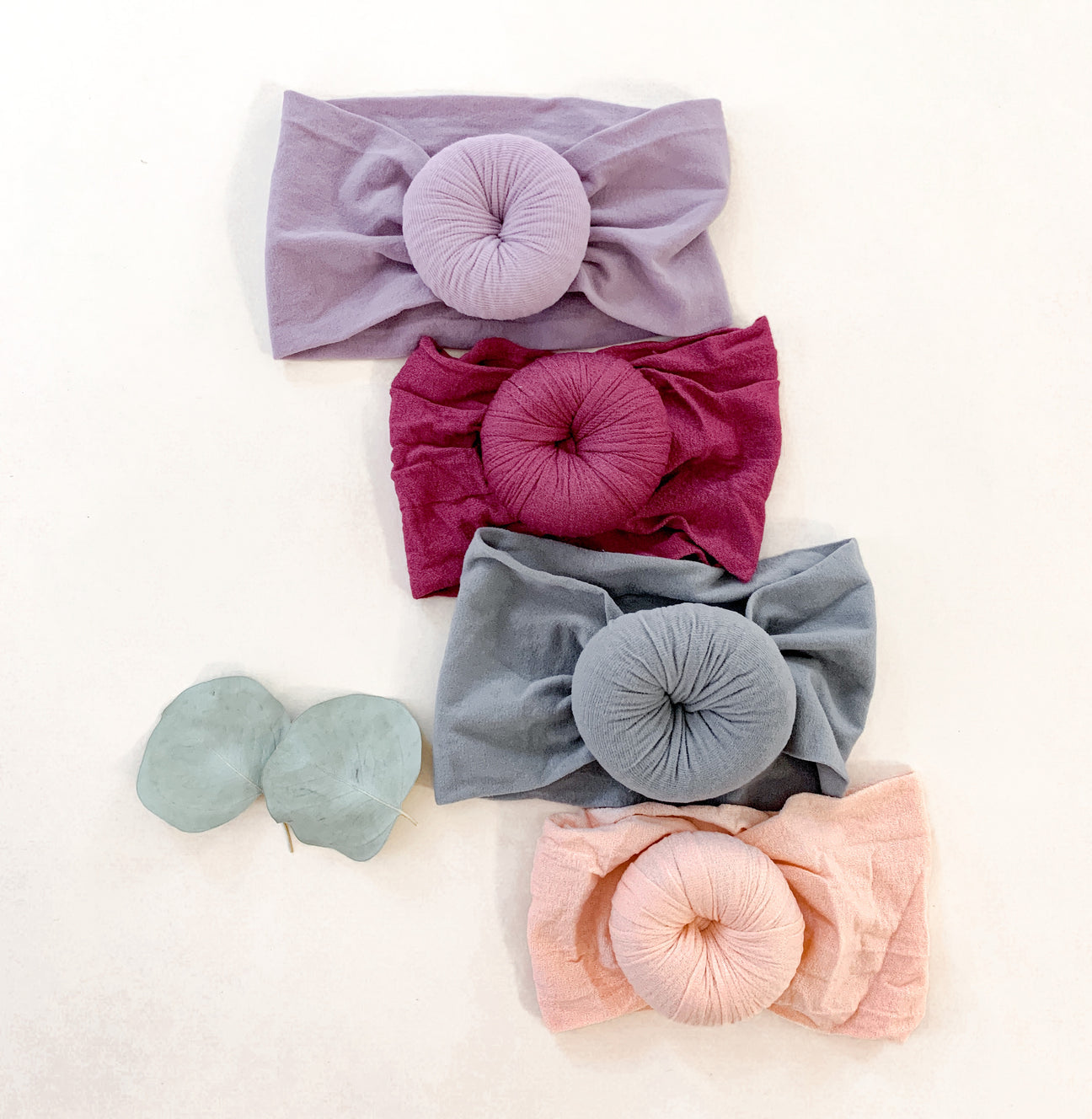 Ella headband made of soft cotton, featuring a stylish design and elastic fit, perfect for various hairstyles.