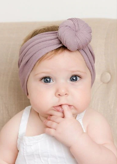 Ella headband made of soft cotton, featuring a stylish design and elastic fit, perfect for various hairstyles.