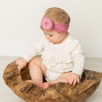 Ella headband made of soft cotton, featuring a stylish design and elastic fit, perfect for various hairstyles.