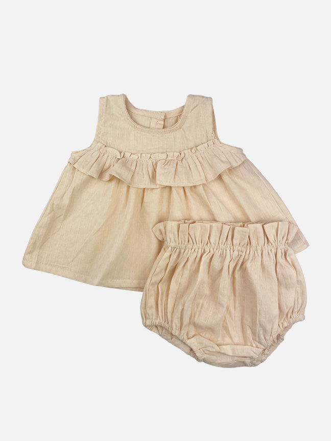 Eloise 2 pc set featuring a pale peach tank top with ruffles and matching bloomer shorts, made of textured cotton fabric.