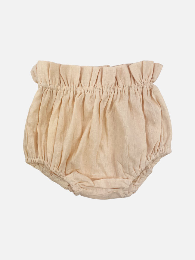 Eloise 2 pc set featuring a pale peach tank top with ruffles and matching bloomer shorts, made of textured cotton fabric.