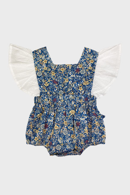 Everly Flutter Bow Onesie in blue floral print with ruffled sleeves and a large bow at the back.