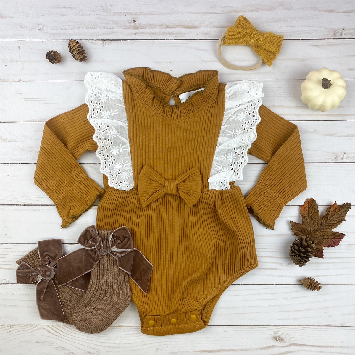 Fall Flutter Onesie in copper with lace flutter details and bow design, perfect for autumn wear.