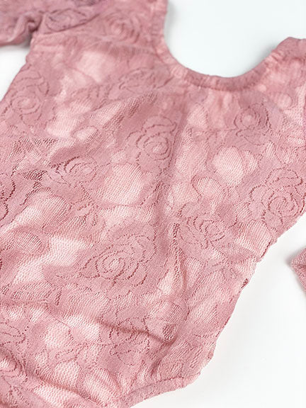 A beautiful floral lace onesie in rose color, featuring see-through lace sleeves and a solid rose leotard body, perfect for stylish comfort.