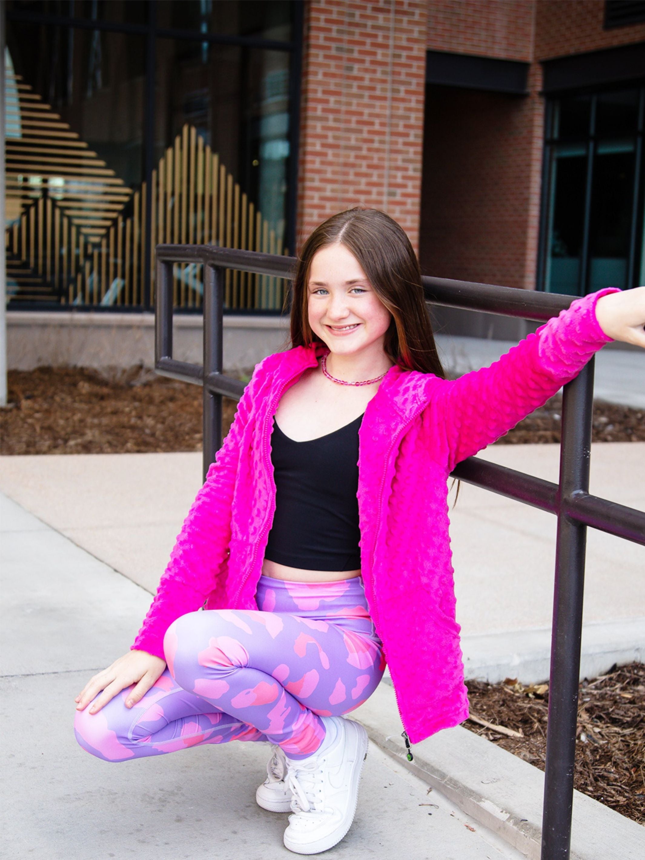 Bright fuchsia minky bubble hoodie paired with printed Rimi active leggings, showcasing a stylish activewear set for kids.