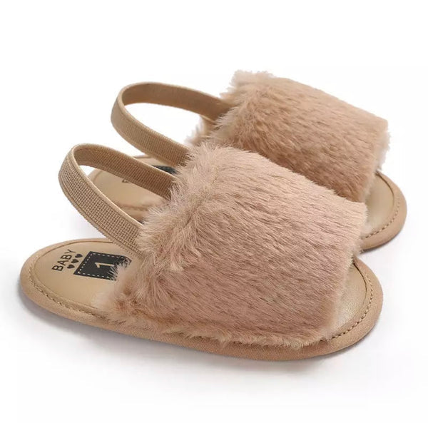 A pair of cozy fuzzy sandals in vibrant colors, perfect for summer beach outings.