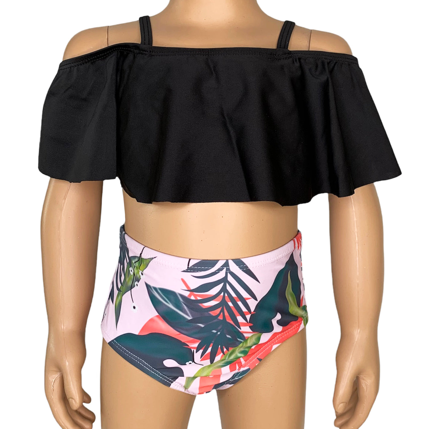 Girls 2 piece black ruffle pink tropical bikini featuring a light pink off-the-shoulder top and high-waisted tropical print bottom.