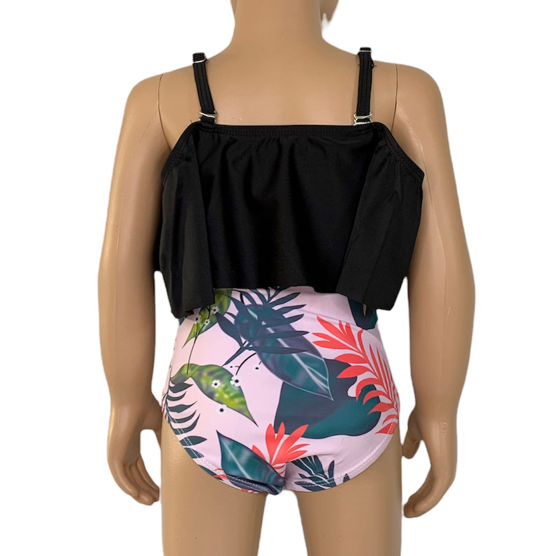 Girls 2 piece black ruffle pink tropical bikini featuring a light pink off-the-shoulder top and high-waisted tropical print bottom.