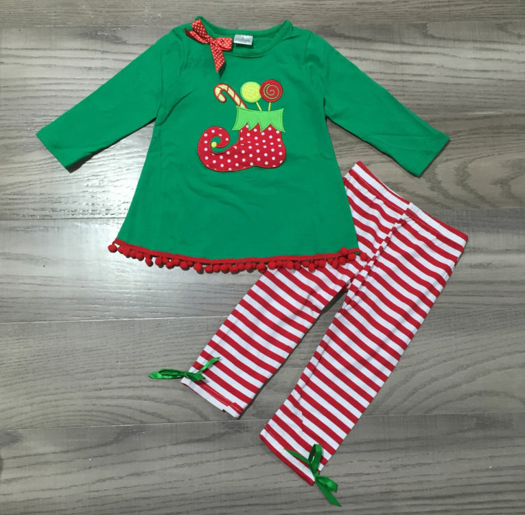 A festive girls outfit featuring an Elf Stocking top with pom pom trim and red & white striped pants, perfect for Christmas celebrations.