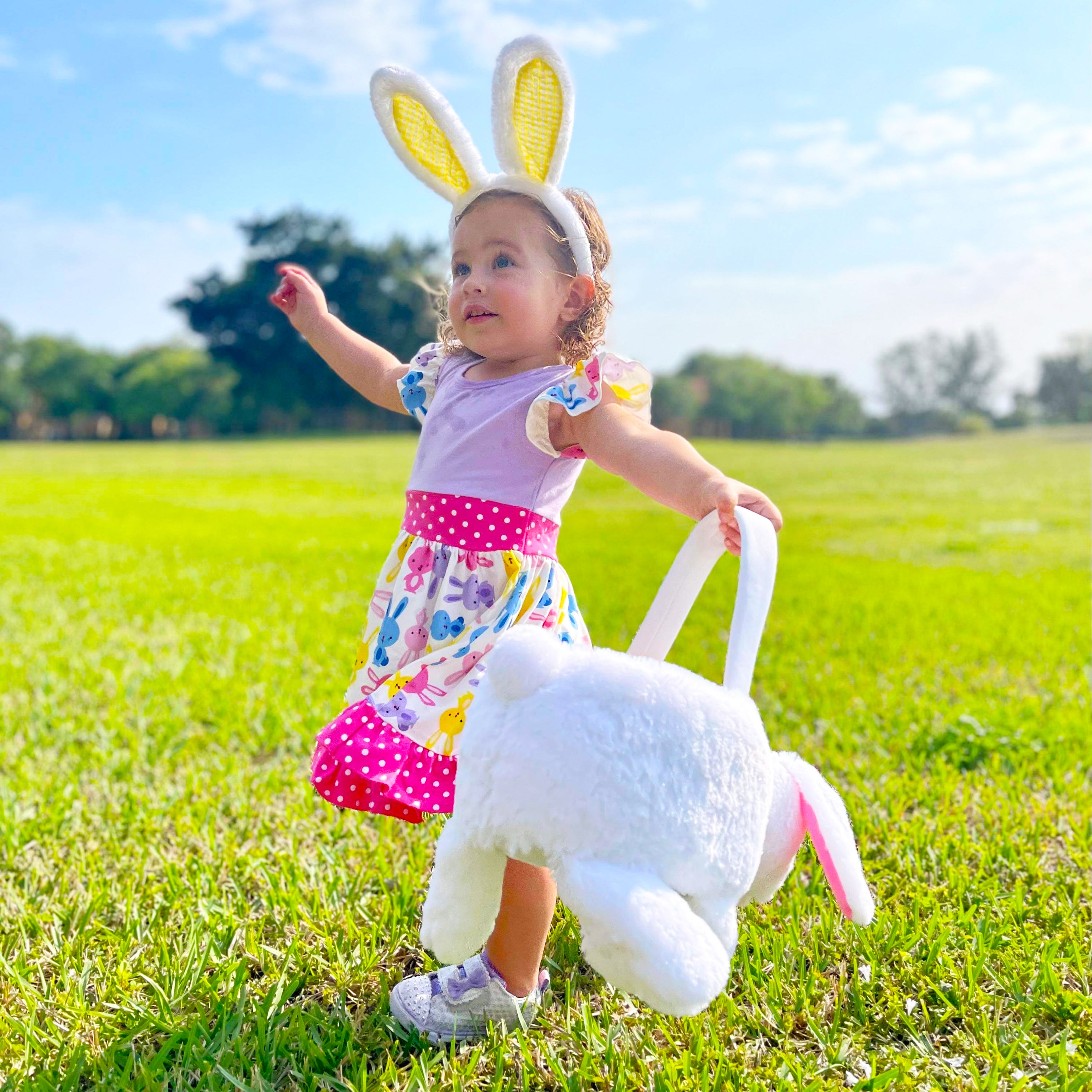 Girls Easter Bunny Dress featuring ruffles, angel cap sleeves, and a playful bunny print in pink and purple.