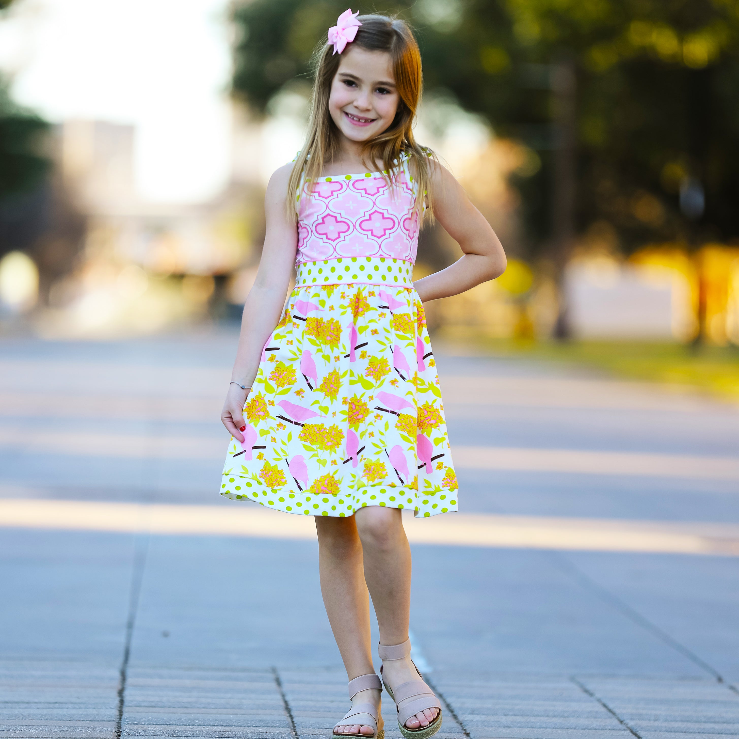 Girls Easter dress featuring spring birds and pink Arabesque print with polka dot sash and bow.