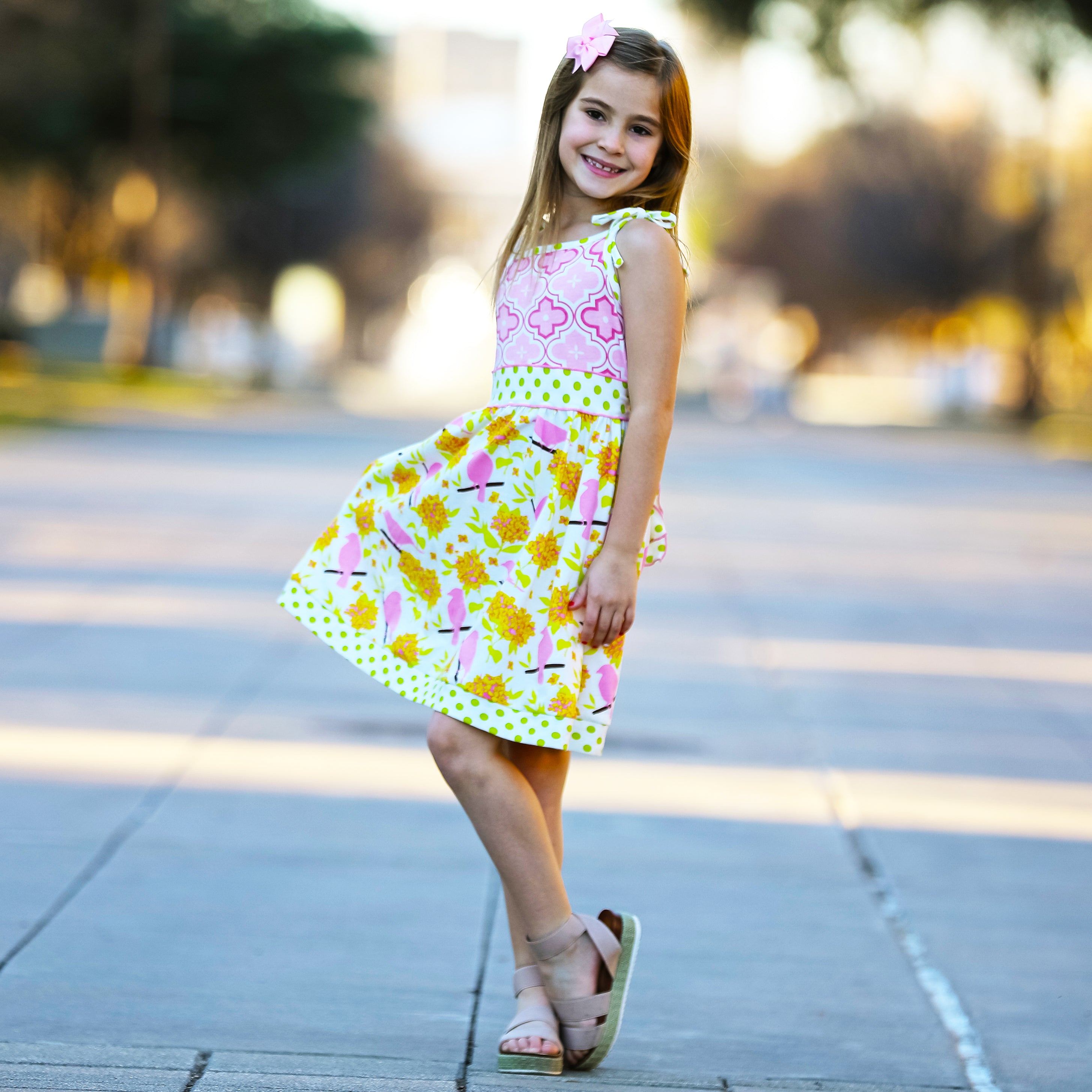 Girls Easter dress featuring spring birds and pink Arabesque print with polka dot sash and bow.