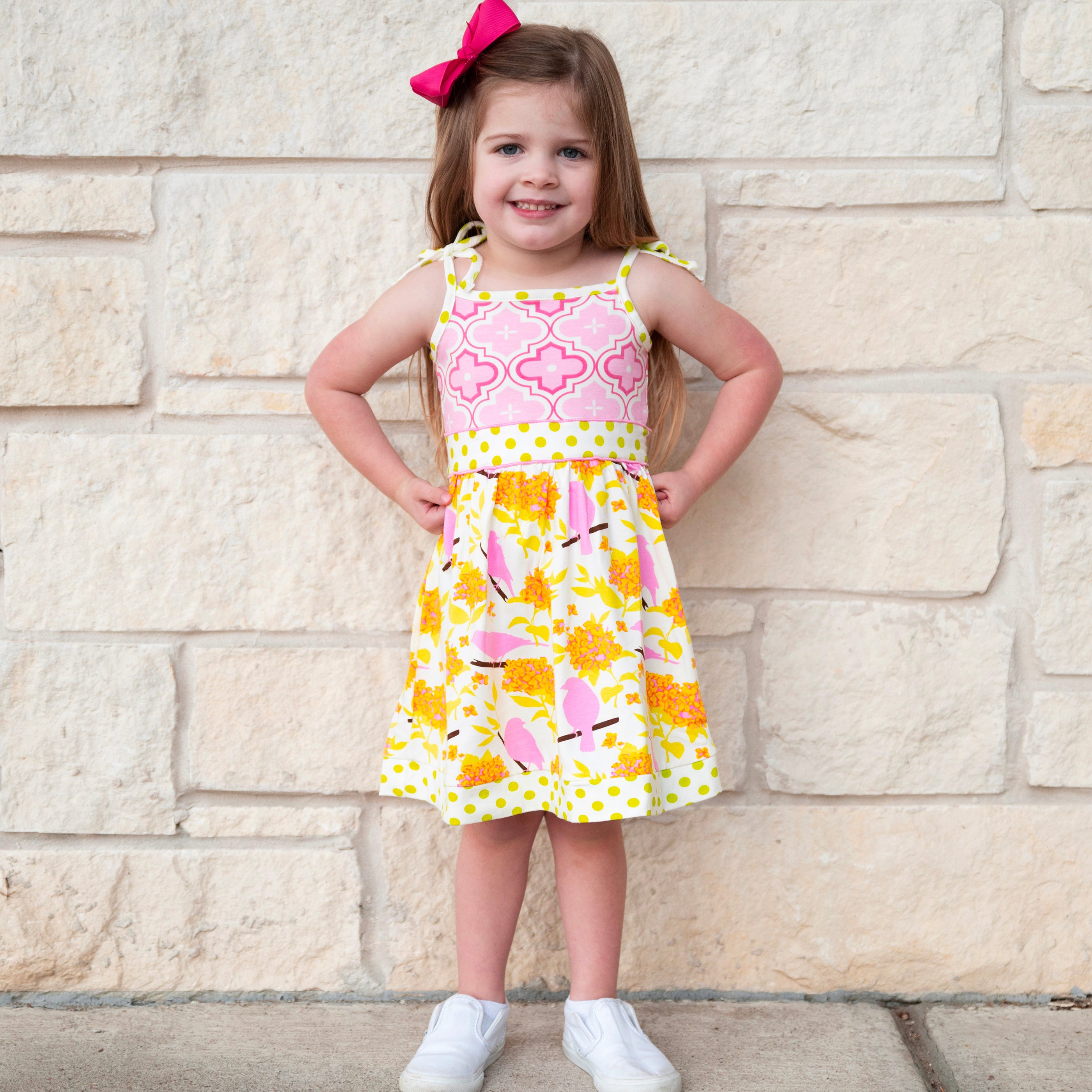 Girls Easter dress featuring spring birds and pink Arabesque print with polka dot sash and bow.