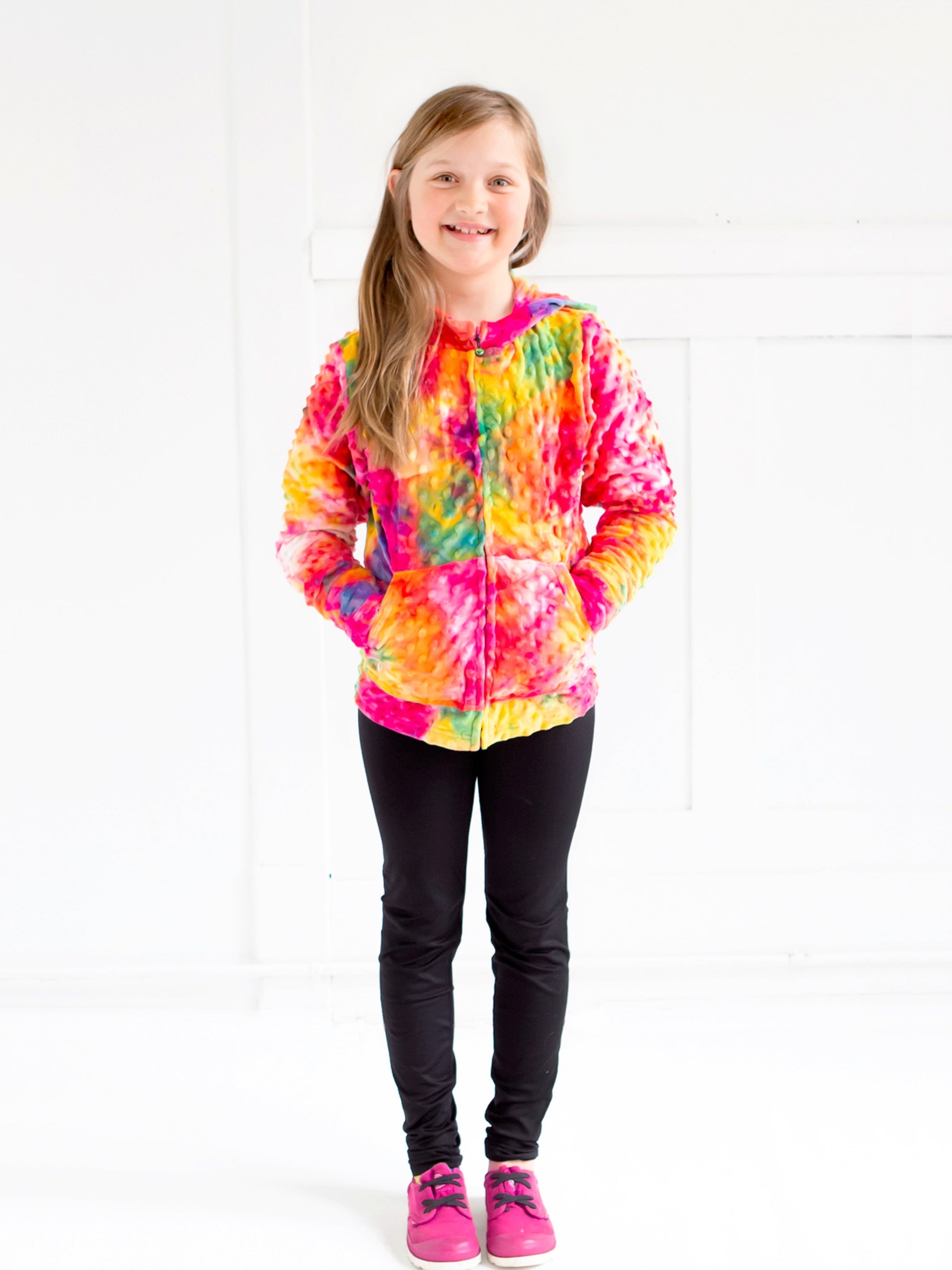 Bright Rainbow Tie Dye Girls Hoodie by Limeapple, featuring vibrant colors and a cozy design, perfect for layering and lounging.