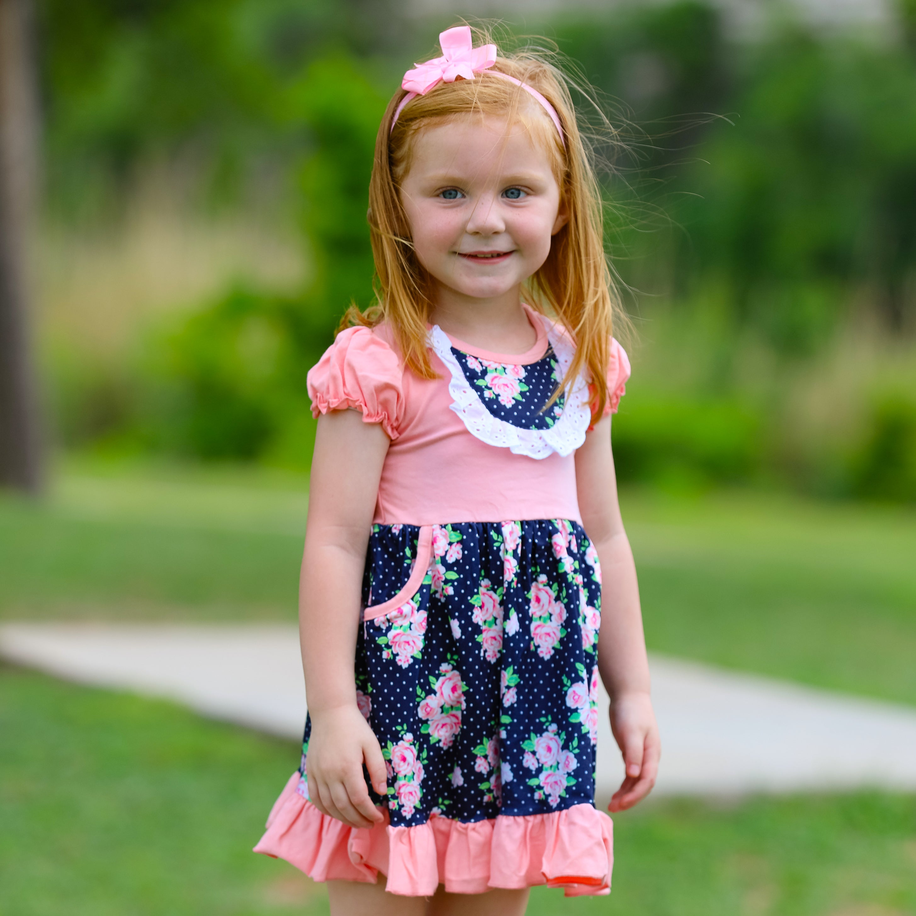 Girls Pink and Blue Floral Bouquet Dress with Ruffles and Pockets, perfect for parties.