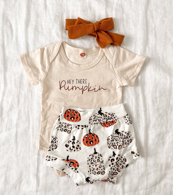 A cute two-piece Halloween outfit set featuring a pumpkin design, made from soft lightweight cotton, perfect for kids.