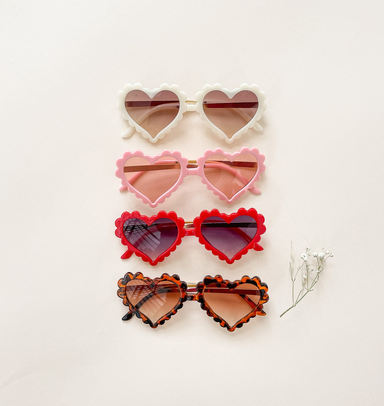 A pair of stylish heart-shaped sunglasses in vibrant colors, perfect for summer wear.