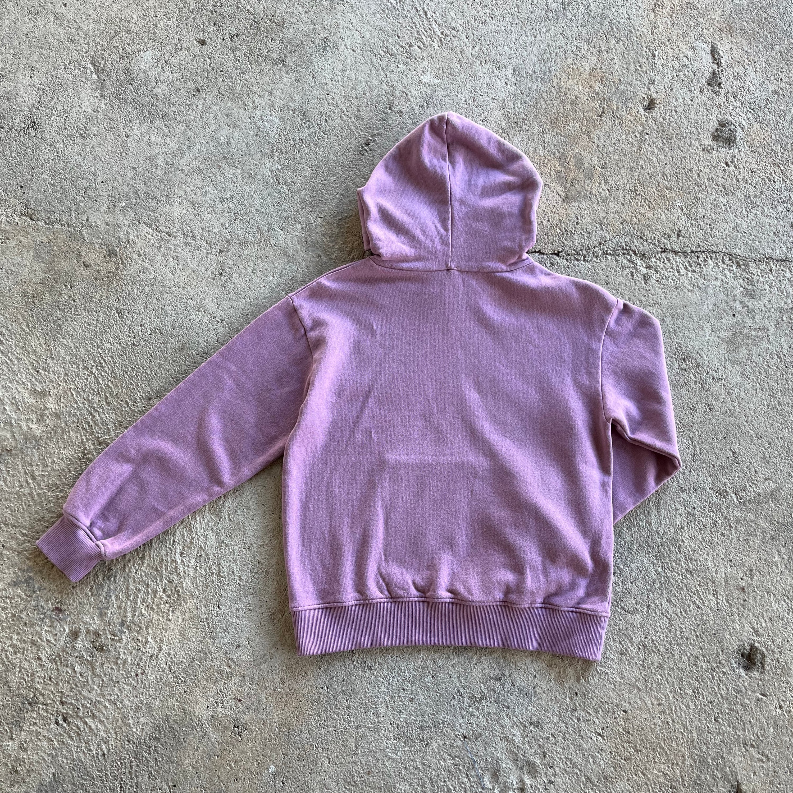 A vibrant orchid-colored kids hoodie featuring long sleeves, ribbed cuffs, and a kangaroo pocket, with 'California' embroidery on the neck.