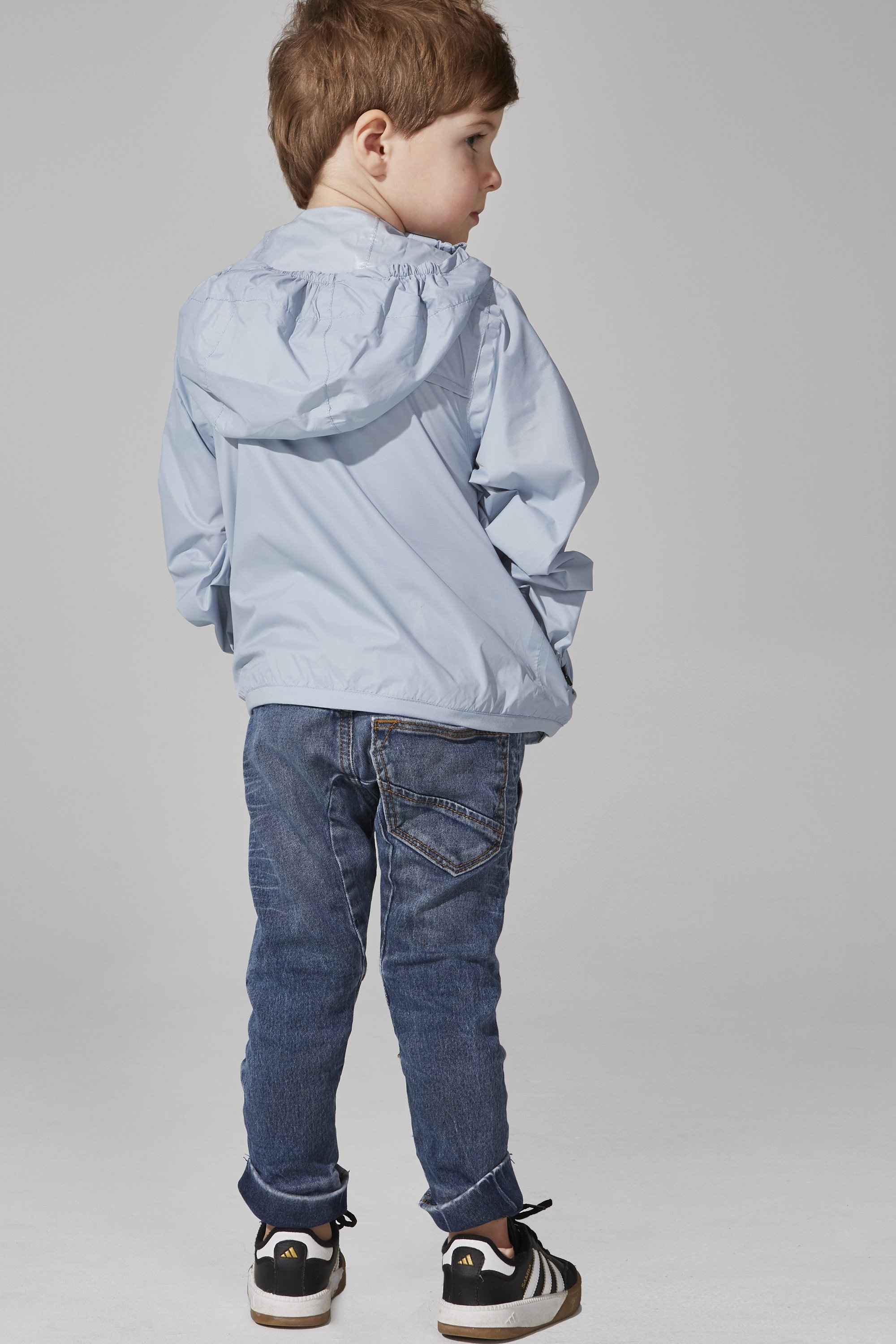 Kids Celestial Blue Full Zip Packable Rain Jacket, showcasing its vibrant color and packable design.