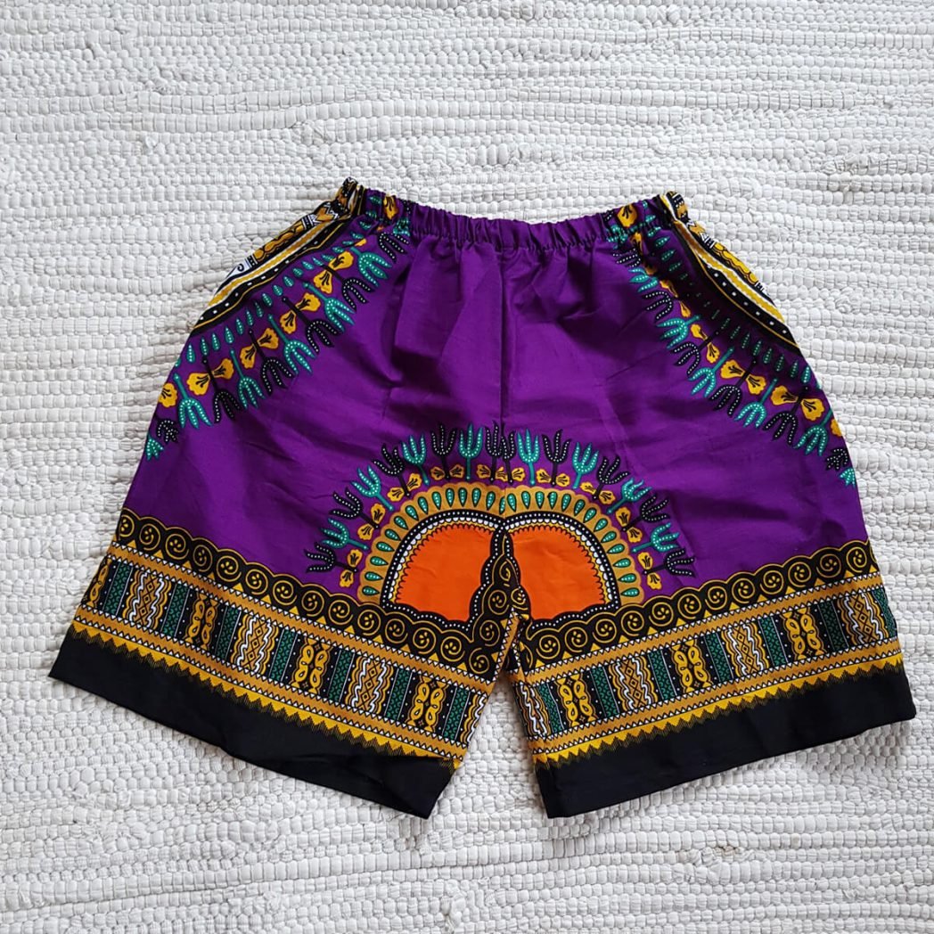 A pair of vibrant purple Kid's Dashiki Shorts made from cotton, featuring an elastic waistband and a casual design, perfect for children.