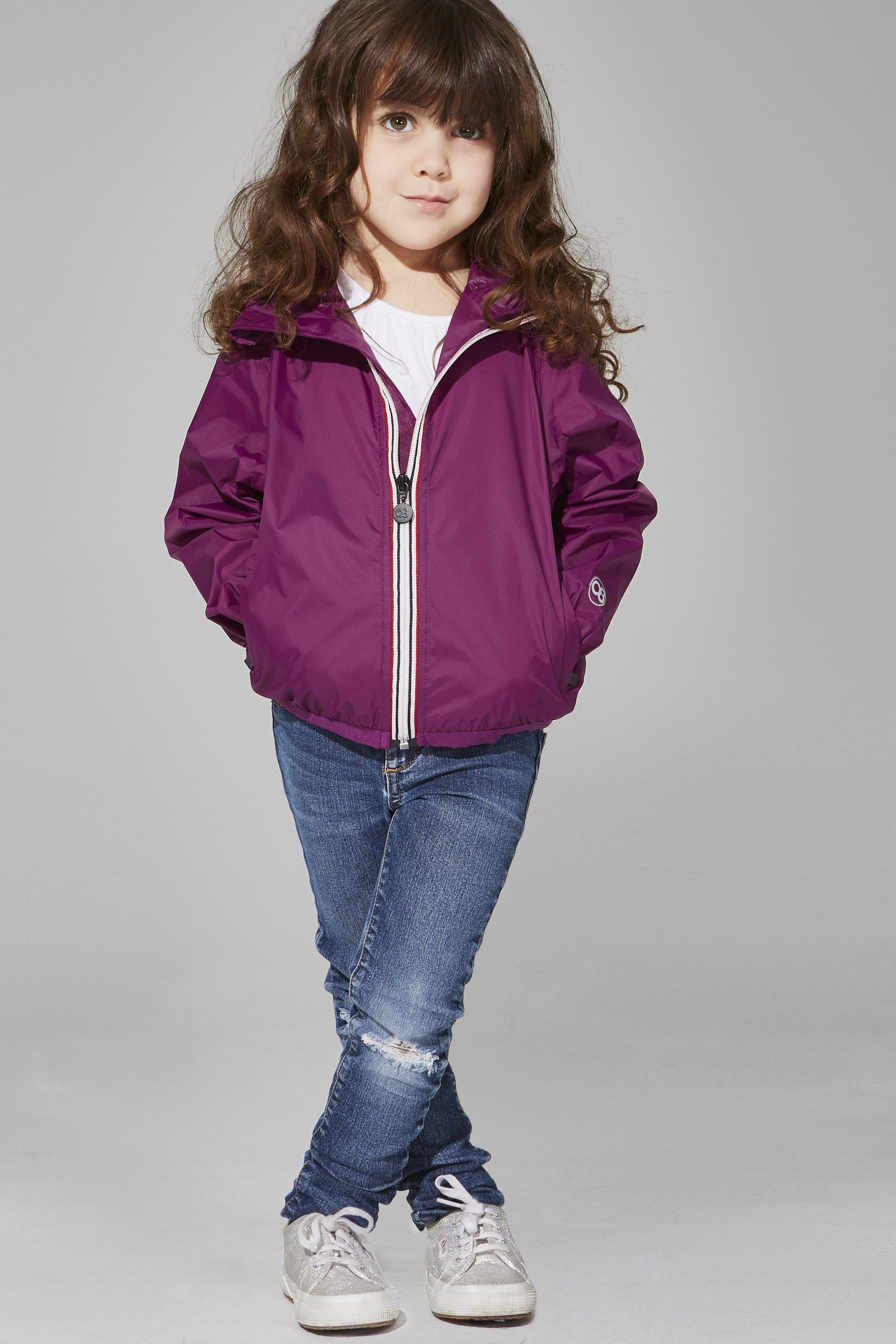 Kids Grape Full Zip Packable Rain Jacket displayed on a hanger, showcasing its vibrant color and full-zip design.